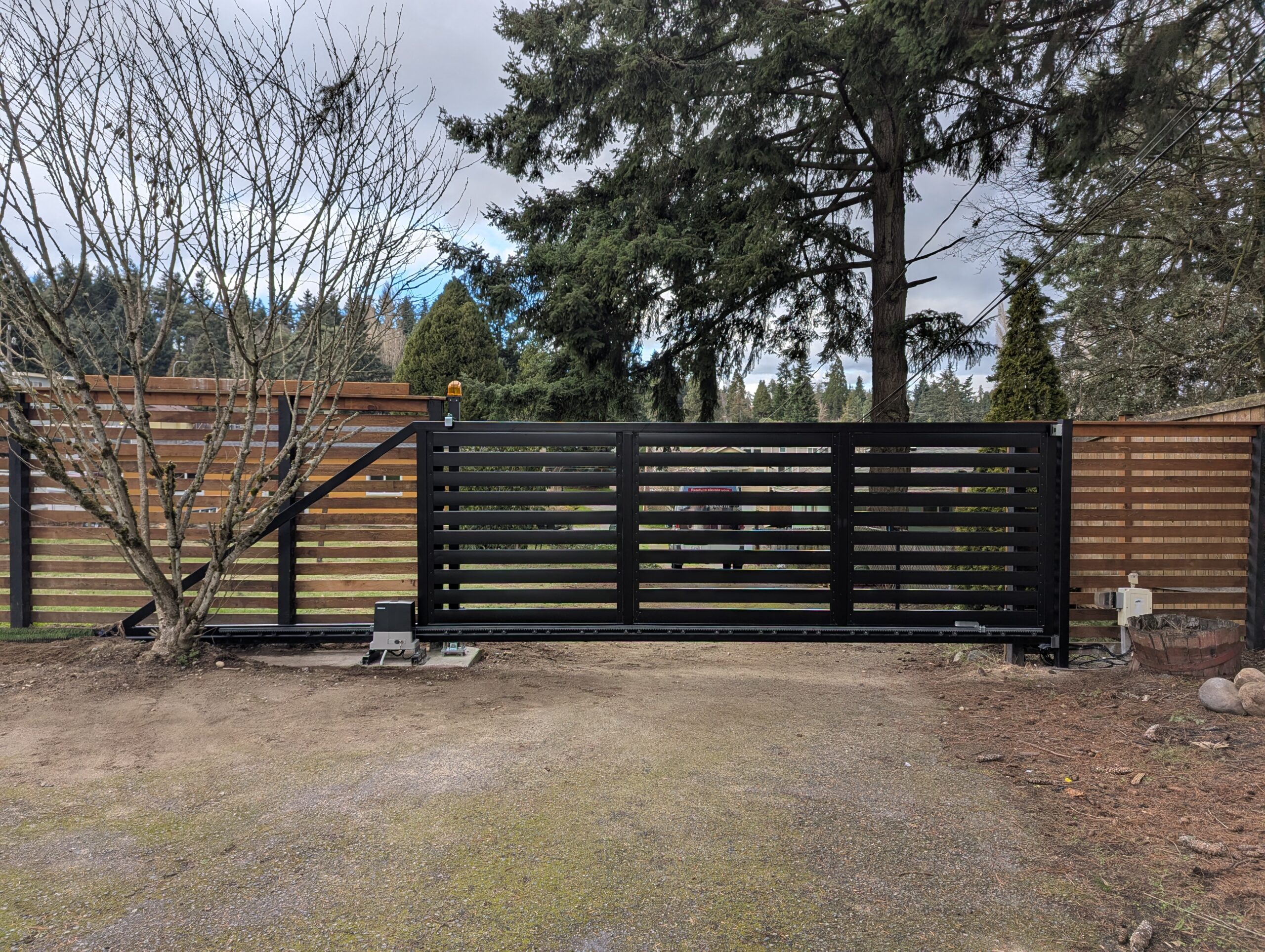 Automatic Cantilever Gate in TERRA Style, Wireless Keypad, and Outdoor Lighting.